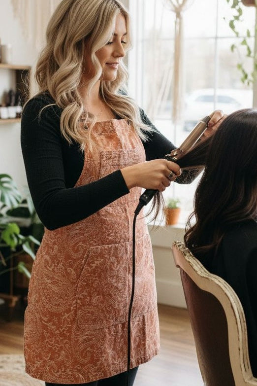 The Bohemian apron by J Clark Designed worn by hair stylist model while working she is styling hair.