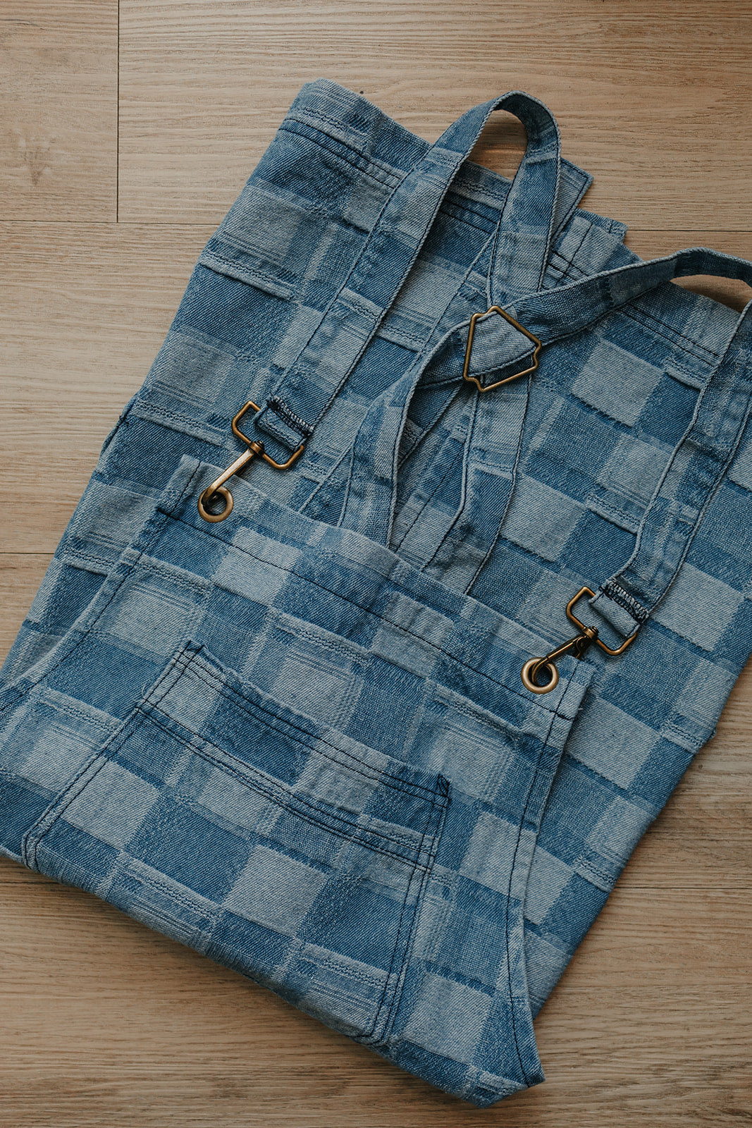 Flat lay close-up detail photo of the Whitmore cross-back salon apron by J Clark Designed