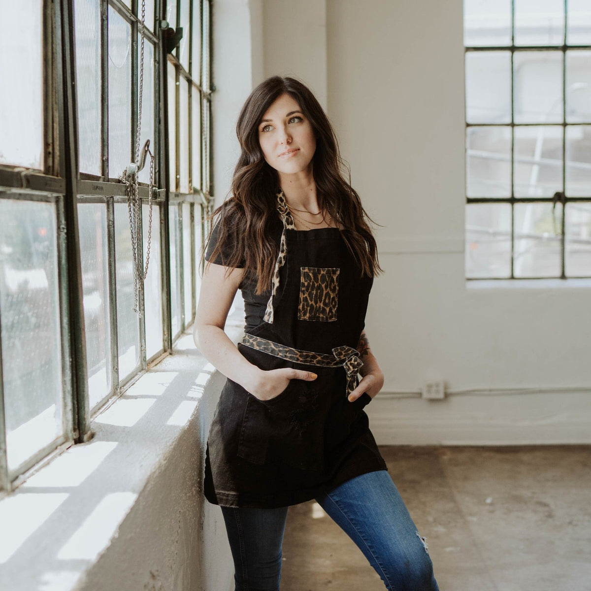 Female model wearing Leopard Two Tone apron by J Clark Designed