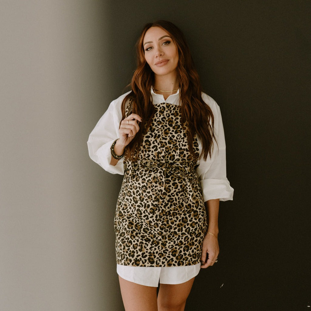 Female model in an oversized white dress shirt wearing The Leo apron by J Clark Designed.