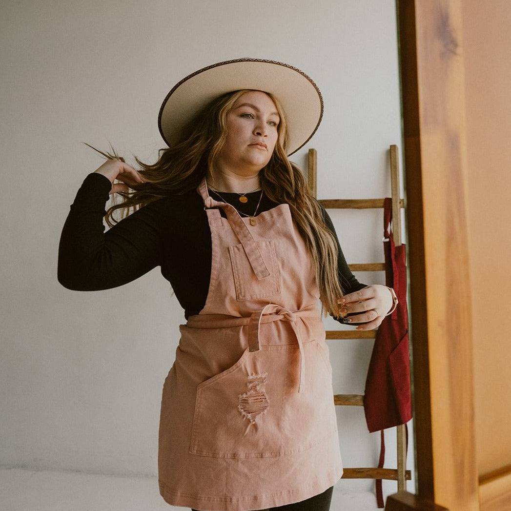 Stylist wearing peach bliss apron