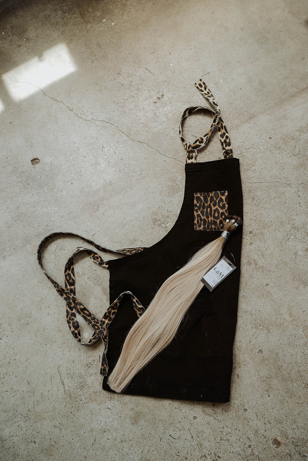Stylist wearing black and leather apron