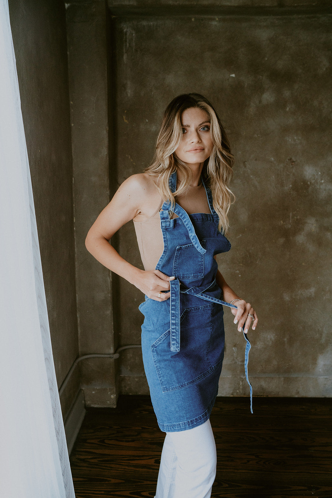Denim apron on model in salon